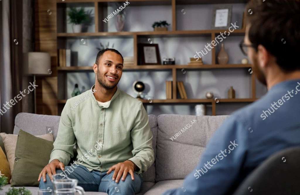 stock-photo-visiting-a-psychologist-a-man-sits-on-a-couch-and-talks-to-a-psychotherapist-he-thanks-the-doctor-2366312565